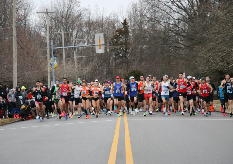 Runners lined up at the starting line of the Frostbite 5 Mile race
